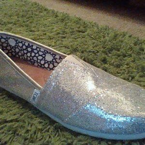 Silver brand new Toms slip ons